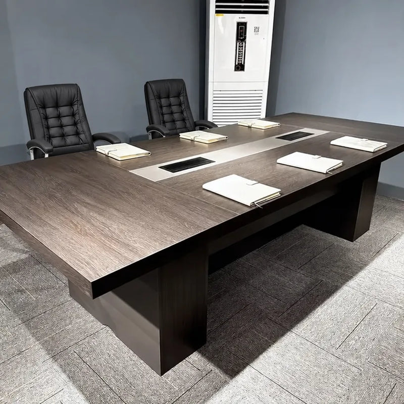 Prime professional meeting table with two leather chairs and a center grommet, client office photo