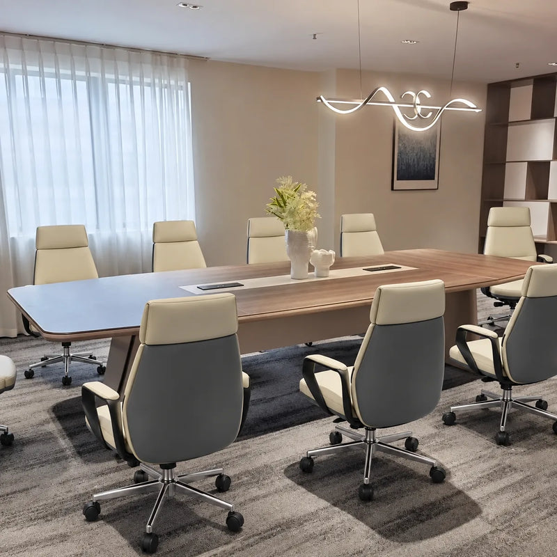Rally brown oak boardroom table with cream and gray chairs beneath a sculptural pendant
