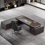 Stellan grand desk with black chair on a hex-pattern rug