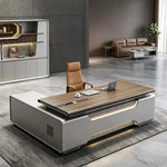 Valence desk, walnut top over sculpted gray base, lounge behind