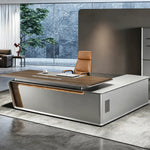 Varell desk, aluminum wedge base, tree beyond the glass