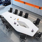 Overhead view of the Vertix white conference table with black leather chairs, laptops and its center diamond cutout