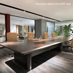 Winslow 19′8″ (236-inch) conference table photographed in a showroom with cream chairs