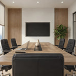 Wright conference table viewed from behind a black leather chair toward the wall screen