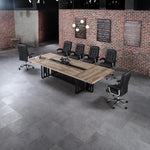 Wright large conference table with black chairs in a loft office with an exposed brick wall