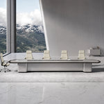 Zenith grand conference table with cream leather chairs in a stone-floored room overlooking snowy mountains